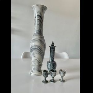 Carved marble vase and wine bottle with cups